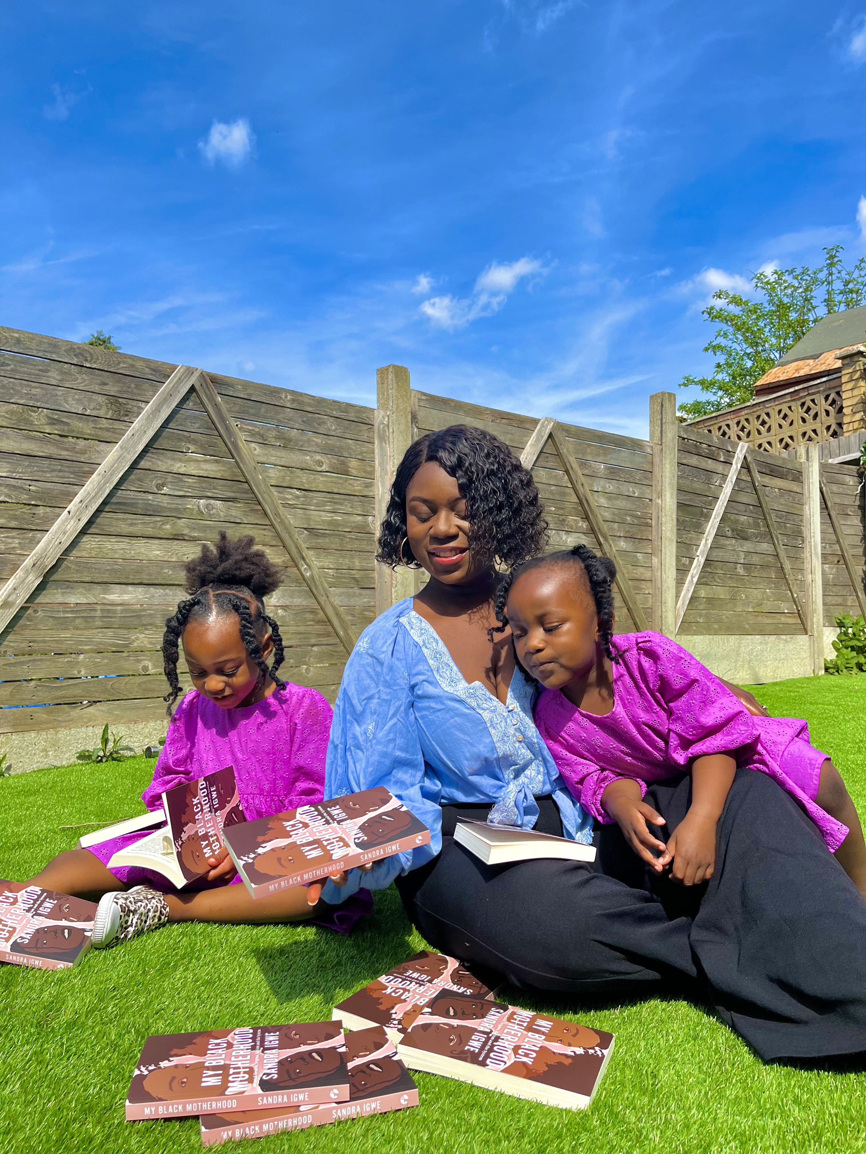 Sandra with her two daughters and her upcoming book, My Black Motherhood