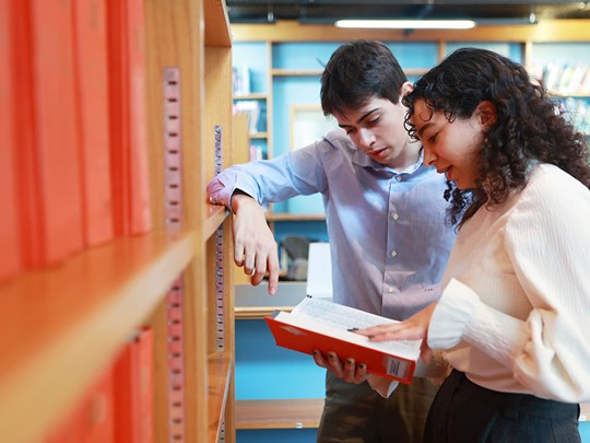 Younger members looking at book